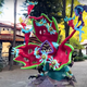 A tall statue of Beth and a Vindicator fighting a space plant and crabs on a Mexico City street.